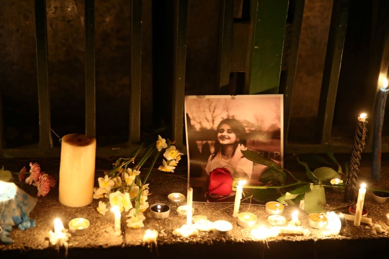 FILE PHOTO: A picture is seen next to candles lit by people and families of the victims of the crash of the Boeing 737-800 plane, flight PS 752, in Tehran