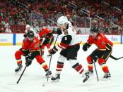 Nov 25, 2018; Glendale, AZ, USA; Arizona Coyotes center Clayton Keller (9) takes a shot on goal against Calgary Flames defenseman Oliver Kylington (58) and Rasmus Andersson (4) in the first period at Gila River Arena. Mark J. Rebilas-USA TODAY Sports