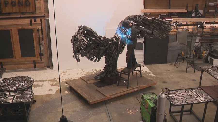 Travis Pond works on his in-progress eagle sculpture that honors the military. April 19, 2024 (KOIN).