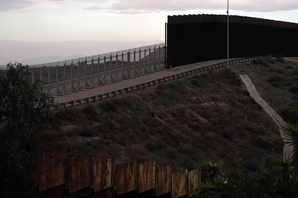 An incomplete secondary wall stands alongside the previous version near where the border separating Tijuana, Mexico, and San Diego meets the Pacific Ocean Tuesday, Jan. 19, 2021, in Tijuana, Mexico. In the days before Joe Biden became president, construction crews worked quickly to finish Donald Trump's wall at an iconic cross-border park overlooking the Pacific Ocean that then-first lady Pat Nixon inaugurated in 1971 as symbol of international friendship. (AP Photo/Gregory Bull)