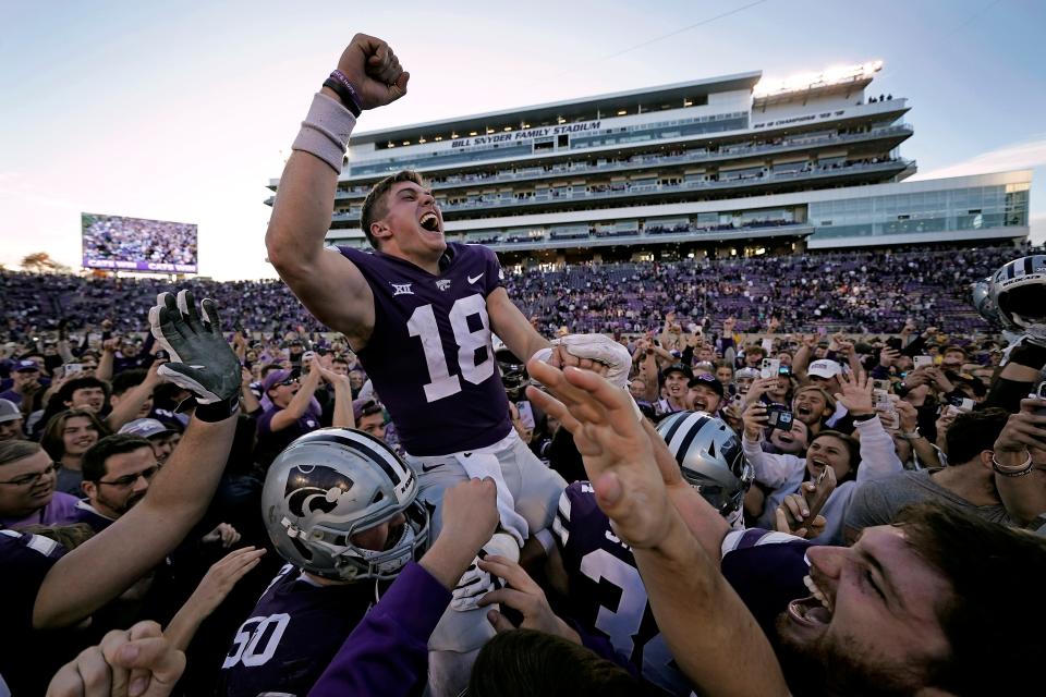 Kansas State quarterback Will Howard (18) celebrates with the crowd as he is carried off the field by teammates after a 48-0 win against Oklahoma State on Saturday.
