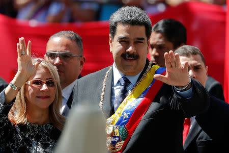 Venezuela's President Nicolas Maduro salutes next to his wife Cilia Flores, during the arrival for a special session of the National Constituent Assembly to present his annual state of the nation in Caracas, Venezuela January 14, 2019. REUTERS/Carlos Garcia Rawlins