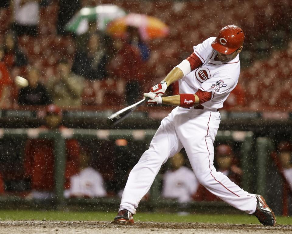 Cincinnati Reds' Joey Votto hits a two-run home run off Pittsburgh Pirates starting pitcher Wandy Rodriguez in the fifth inning of a baseball game, Monday, April 14, 2014, in Cincinnati. (AP Photo/Al Behrman)