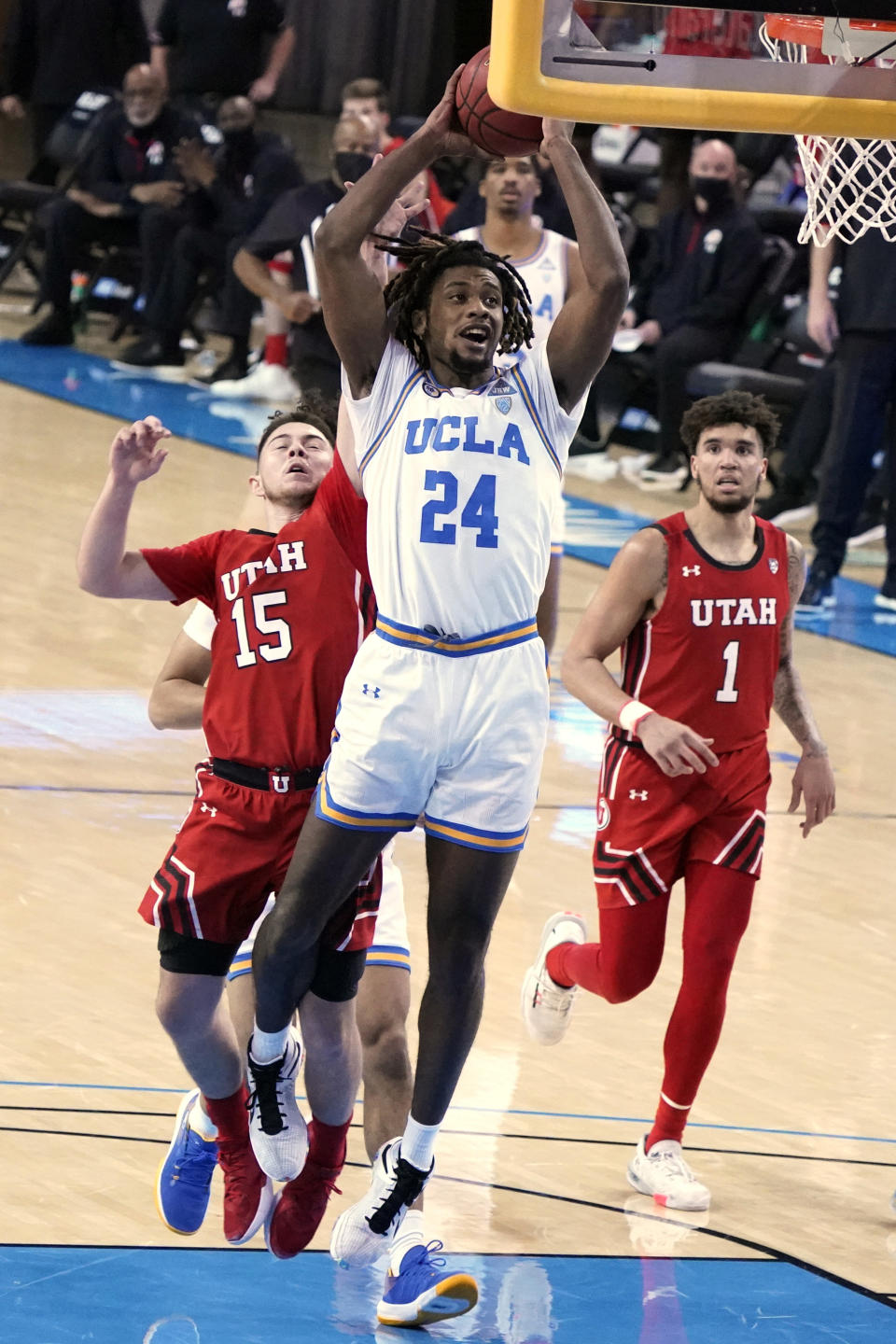 UCLA forward Jalen Hill (24) drives past Utah guard Rylan Jones (15) during the second half of an NCAA college basketball game Thursday, Dec. 31, 2020, in Los Angeles. (AP Photo/Marcio Jose Sanchez)