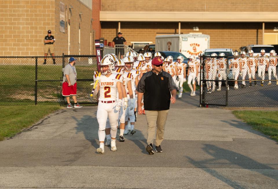  The Gibson Southern Titans walk onto the field before their game against the Southridge Raiders at Southridge High School in Huntingburg, Ind., Friday evening, Sept. 16, 2022. 