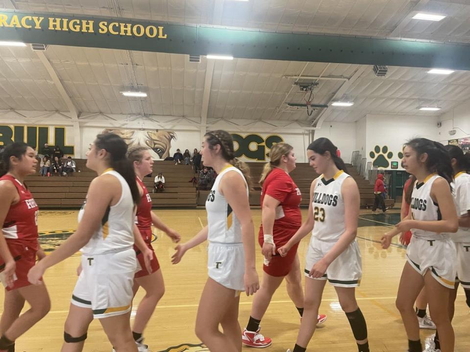 Tracy and Ripon girls basketball players shake hands after their game on Thursday, Dec. 29, 2022.
