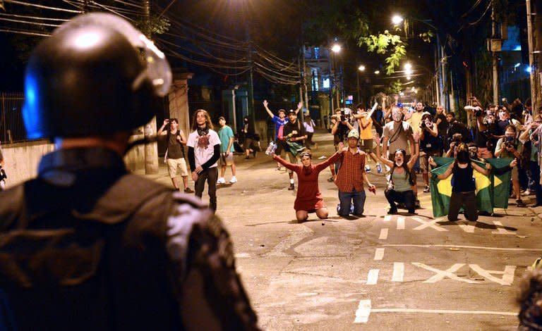 Protestors clash with riot squad officers on a street near Maracana stadium in Rio de Janeiro, Brazil on June 30, 2013. The demonstrators responded to calls on social media to turn out to back the national squad but also to protest the country's inadequate public services -- a key gripe at the core of two weeks of demonstrations that have rocked the South American giant