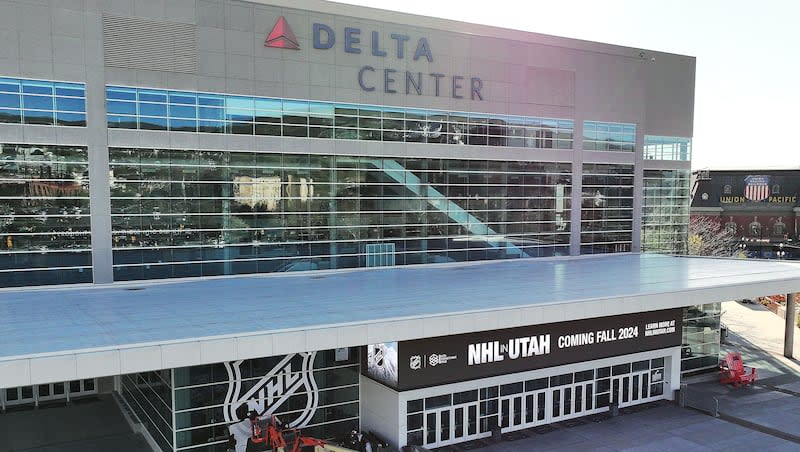 Vision Graphics crews install an NHL banner on the Delta Center in Salt Lake City on Thursday, April 18, 2024. Jazz owner Ryan Smith bought the Arizona Coyotes and they will relocate to Salt Lake City.