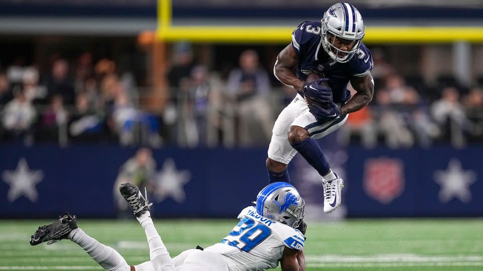 Dallas Cowboys wide receiver Brandin Cooks tries to avoid a tackle by Detroit Lions cornerback Kindle Vildor. - Sam Hodde/AP