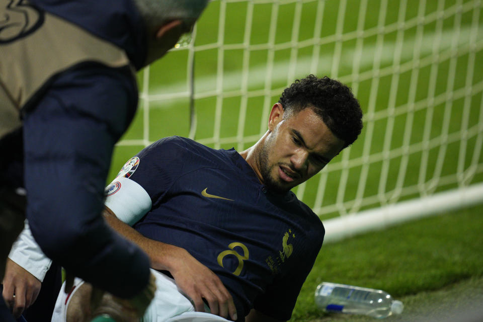 Injured France's Warren Zaire-Emery is provided assistance during the Euro 2024 group B qualifying soccer match between France and Gibraltar in Nice, France, Saturday, Nov. 18, 2023. (AP Photo/Daniel Cole)