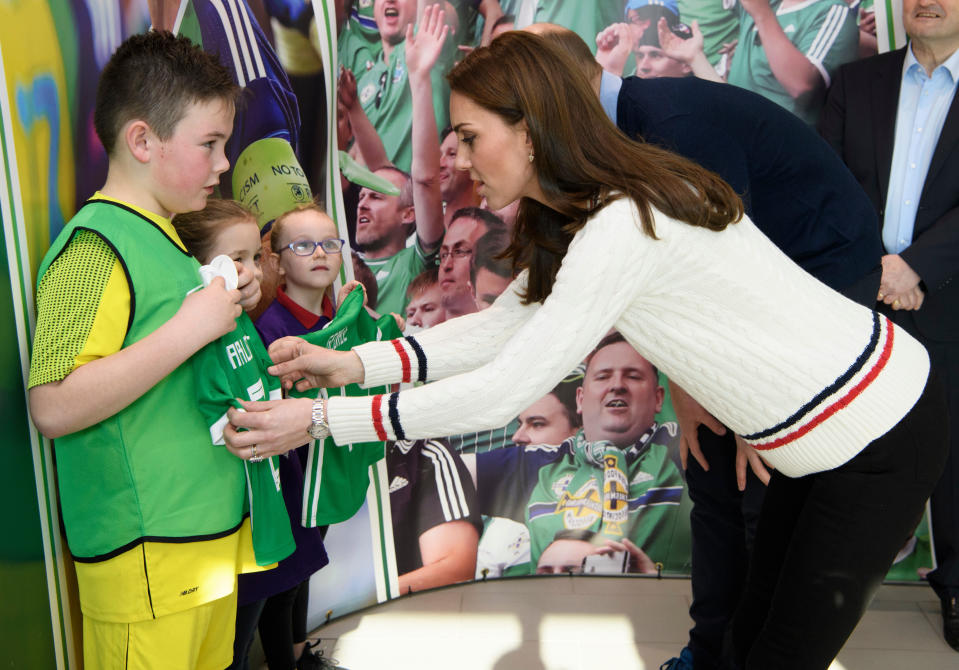 BELFAST, NORTHERN IRELAND - FEBRUARY 27:  Catherine, Duchess of Cambridge and Prince William, Duke of Cambridge are given football shirts for their children during a visit the National Stadium in Belfast, home of the Irish Football Association on February 27, 2019 in Belfast, Northern Ireland. Prince William last visited Belfast in October 2017 without his wife, Catherine, Duchess of Cambridge, who was then pregnant with the couple's third child.  This time they concentrate on the young people of Northern Ireland. Their engagements include a visit to Windsor Park Stadium, home of the Irish Football Association, activities at the Roscor Youth Village in Fermanagh, a party  at the Belfast Empire Hall, Cinemagic -a charity that uses film, television and digital technologies to inspire young people and finally dropping in on a SureStart early years programme.  (Photo by Tim Rooke - Pool/Getty Images)