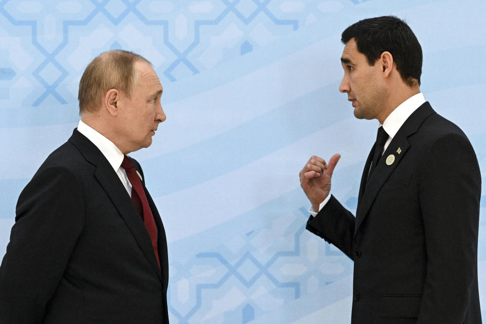 Russian President Vladimir Putin, left, listens to Turkmenistan's President Serdar Berdymukhamedov, 40-year old son of former Turkmenistan President Gurbanguly Berdimuhamedov, during their meeting on the sideline of the summit of Caspian Sea littoral states in Ashgabat, Turkmenistan, Wednesday, June 29, 2022. (Grigory Sysoyev, Sputnik, Kremlin Pool Photo via AP)