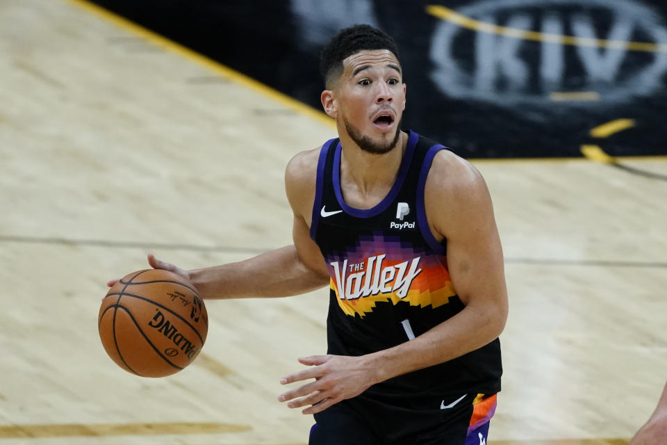 Phoenix Suns guard Devin Booker reacts to a call during the second half of the team's NBA basketball game against the New Orleans Pelicans, Tuesday, Dec. 29, 2020, in Phoenix. (AP Photo/Rick Scuteri)