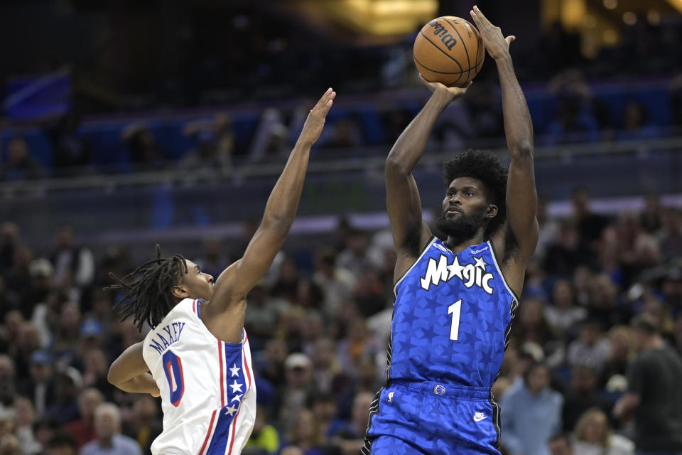 Orlando Magic forward Jonathan Isaac (1) shoots in front of Philadelphia 76ers guard Tyrese Maxey (0) during the first half of an NBA basketball game, Friday, Jan. 19, 2024, in Orlando, Fla. (AP Photo/Phelan M. Ebenhack)