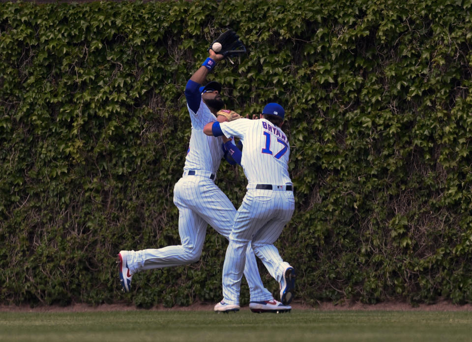 Chicago Cubs center fielder Jason Heyward, left, and right fielder Kris Bryant (17) collide while chasing a ball hit by Cincinnati Reds'c Eugenio Suarez (7) during the sixth inning of a baseball game Sunday, May 26, 2019, in Chicago. Bryant was charged with an error on the play. (AP Photo/Matt Marton)