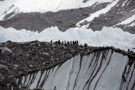 Trekkers stand in Everest Base camp, approximately 5,300 meters (17,388 ft) above sea level, in Solukhumbu District, Nepal, in this file picture taken May 6, 2014. REUTERS/Navesh Chitrakar