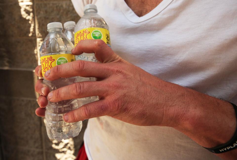 A person requesting water for a friend during the lunch food distribution at The Midnight Mission.