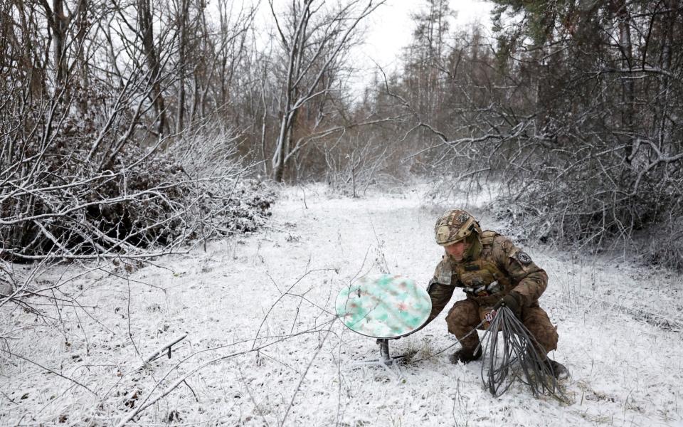 Member of the 80th Separate Air Assault Brigade disconnects a Starlink on the frontline region of Kreminna, Ukraine, on Jan 6