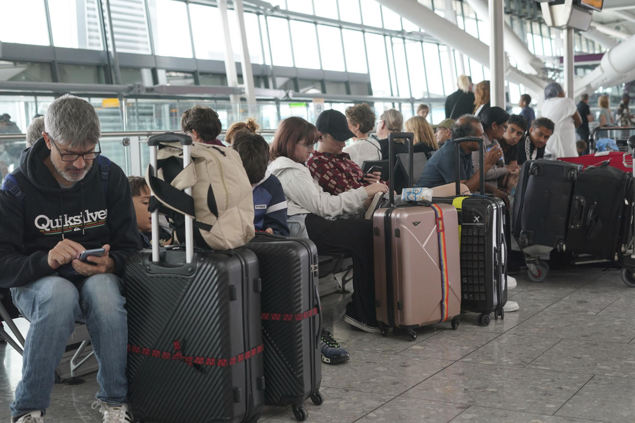 Passengers are seen waiting for delayed flights in London's Heathrow airport, Tuesday, Aug. 29, 2023. The British government says a cyberattack was not the cause of a breakdown at the nationwide air traffic control system that saw hundreds of flights delayed and canceled. The problem hit on a late-summer holiday Monday that is one of the busiest days of the year for air travel. Transport Secretary Mark Harper says it will 