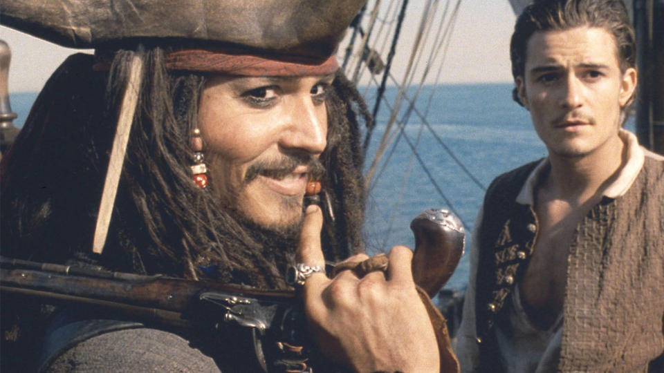 Captain Jack Sparrow and Will Turner on the deck of a ship in Pirates of the Caribbean