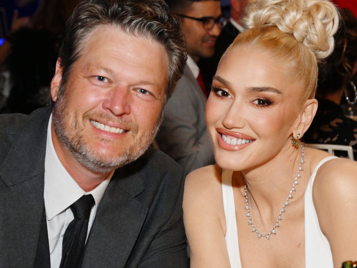 Blake Shelton and Gwen Stefani hold hands and smile at the AFI Life Achievement Award Gala