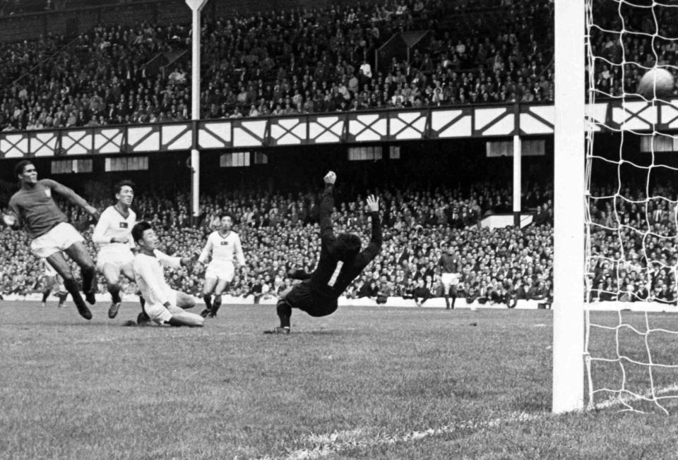 FILE - In this July 23, 1966 file photo, Portugal's Eusebio, left, scores one of his four goals during the World Cup quarterfinal match against North Korea at Goodison Park, Liverpool. Portugal defeated North Korea 5-3. Eusebio, the Portuguese football star who was born into poverty in Africa but became an international sporting icon and was voted one of the 10 best players of all time, has died of heart failure aged 71, Sunday, Jan. 5 2014. (AP Photo/Bippa, File)