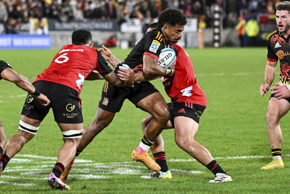 Emoni Narawa of the Chiefs runs at the defense during the Super Rugby Pacific final between the Chiefs and the Crusaders in Hamilton, New Zealand, Saturday, June 24, 2023. (Andrew Cornaga/Photosport via AP)