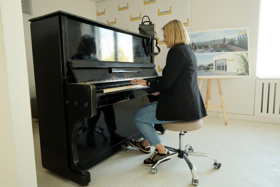 Viktoriia Tarasiuk, country manager for Ukraine and director of the August Mission Foundation of Ukraine, sits down and play a piano while touring a rehab hospital in Ukraine on Saturday, May 6, 2023. | Scott G Winterton, Deseret News