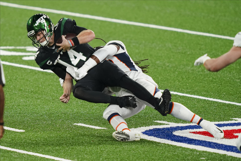 New York Jets quarterback Sam Darnold (14) is sacked by Denver Broncos' A.J. Johnson during the first half of an NFL football game Thursday, Oct. 1, 2020, in East Rutherford, N.J. (AP Photo/John Minchillo)