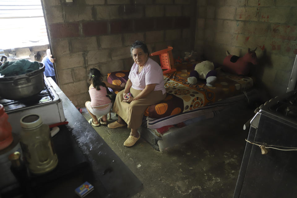 Jesús Esperanza Ventura, who helps care for her great-grandchildren, sits on the bed her granddaughter Juana Guadalupe Recinos used to sleep on, in Santa Ana, El Salvador, Wednesday, Jan. 31, 2024. Recinos, a single mother of two, was detained last year during the government's crackdown on its war against drugs, leaving her sons motherless for more than a year. (AP Photo/Salvador Melendez)