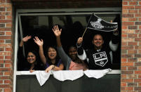 LOS ANGELES, CA - JUNE 14: Fans cheer for the Los Angeles Kings team menbers during the Stanley Cup victory parade on June 14, 2012 in Los Angeles, California. The Kings are celebrating their first NHL Championship in the team's 45-year-old franchise history. (Photo by Kevork Djansezian/Getty Images)