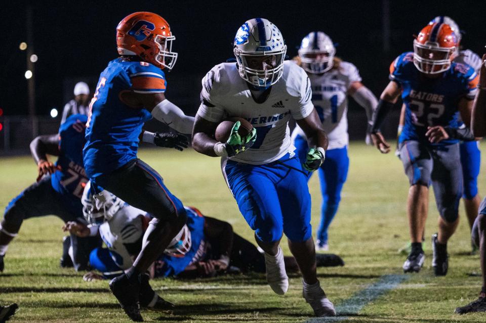 Wellington running back Garrens Catul Jr (7) carries the ball into the end zone for a touchdown in the first quarter during the Class 4M regional quarterfinal game between host Palm Beach Gardens and Wellington on Monday, November 14, 2022, in Palm Beach Gardens, FL. Final score, Palm Beach Gardens, 30, Wellington, 13.