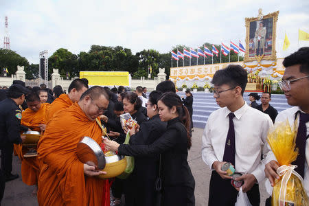 Well-wishers offer alms to Buddhist monks as part of the celebrations for the 65th birthday of Thai King Maha Vajiralongkorn in Bangkok, Thailand, July 28, 2017. REUTERS/Athit Perawongmetha