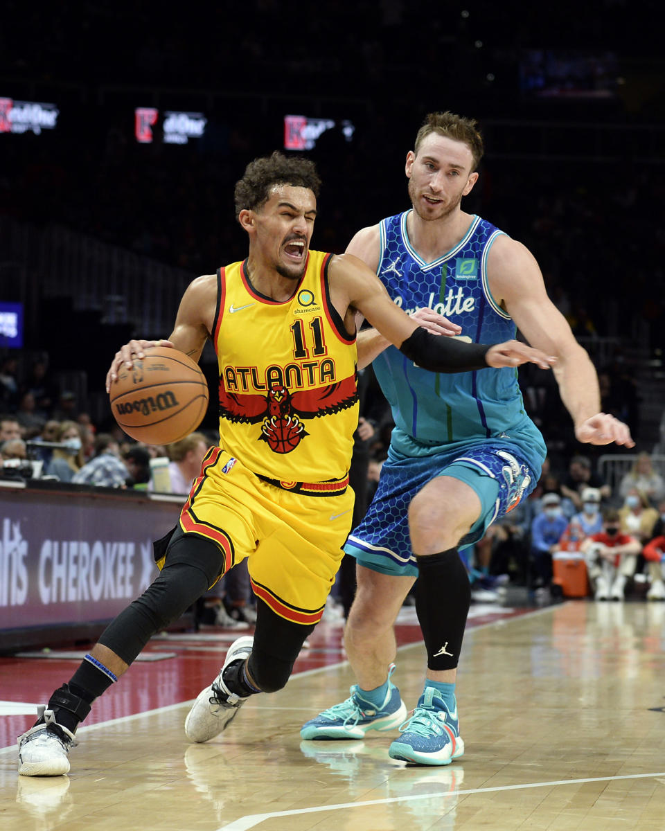 Atlanta Hawks guard Trae Young drives around Charlotte Hornets forward Gordon Hayward during the first half of an NBA basketball game on Sunday, Dec. 5, 2021, in Atlanta. (AP Photo/Edward M. Pio Roda)