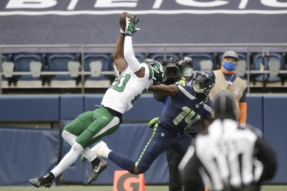 New York Jets' safety Marcus Maye (20) intercepts a pass intended for Seattle Seahawks wide receiver DK Metcalf (14) during the first half of an NFL football game, Sunday, Dec. 13, 2020, in Seattle. (AP Photo/Lindsey Wasson)