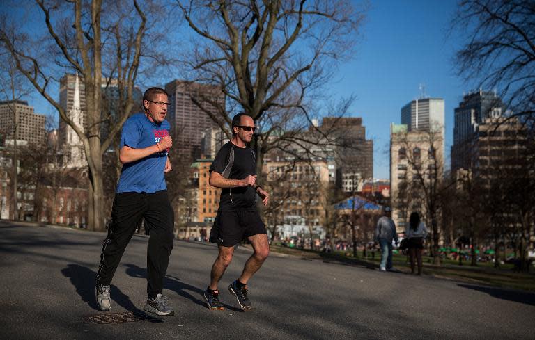 Runners are seen on Boston Common two days before the Boston Marathon on April 19, 2014