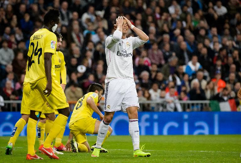 Real Madrid's forward Cristiano Ronaldo (R) reacts during the Spanish league football match Real Madrid CF vs Villarreal CF at the Santiago Bernabeu stadium in Madrid on March 1, 2015