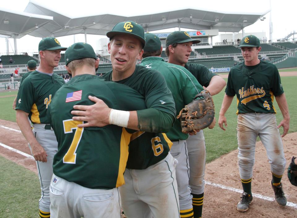 John Capra and Will Erdman of MCC embrace after winning the Class 3A state baseball semifinal in Fort Myers Monday, May 20, 2013.