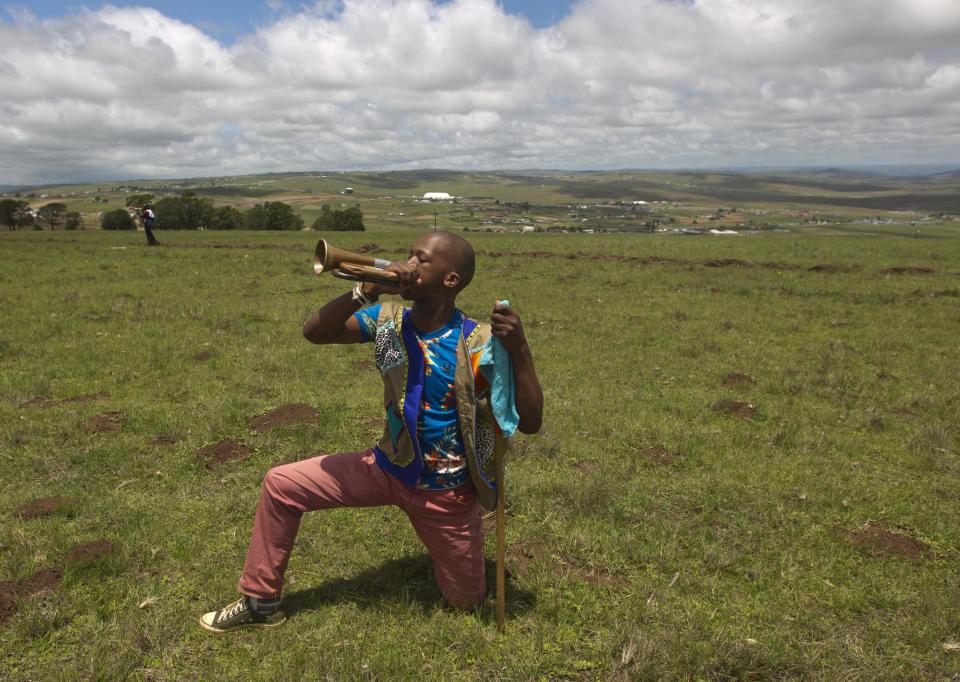 A Zulu man plays a bugle after the funeral of former South African President Nelson Mandela in Qunu