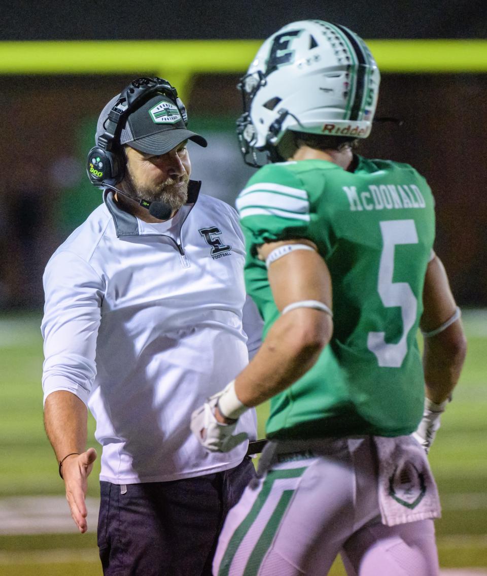 Eureka head coach Jason Bachman congratulates John McDonald after a successful drive in the first half of their Week 3 football game in Eureka. The Hornets knocked off the Maroons 47-28.