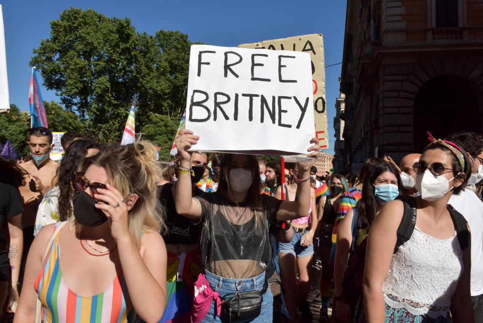 Protesters wearing masks and holding up signs, including "Free Britney"