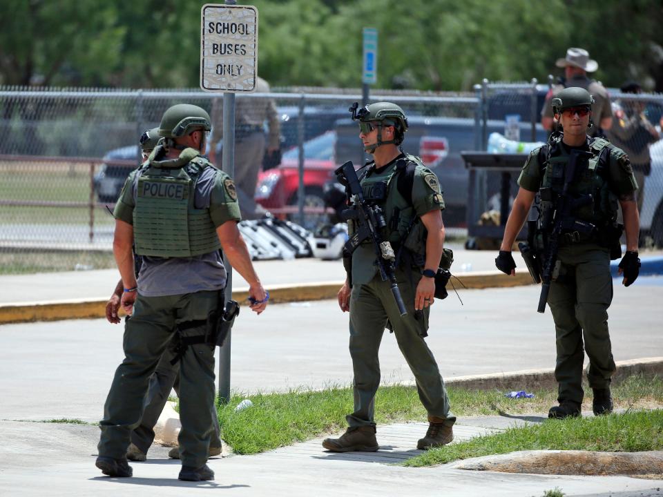 Law enforcement personnel stand outside Robb Elementary School following a shooting, Tuesday, May 24, 2022, in Uvalde, Texas.