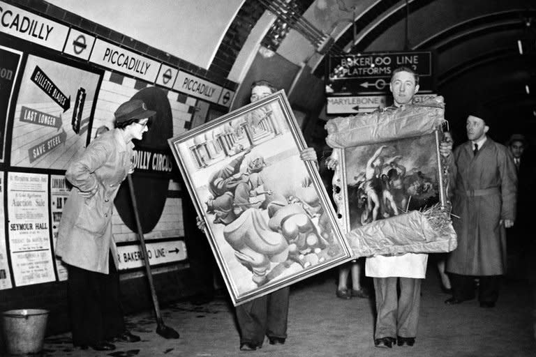 People carry paintings in the London Underground as a cleaning woman looks on in 1946. The London Underground began celebrating its 150th birthday on Wednesday, creaking under the demand of four million daily passengers as it looked back to the opening of the world's first underground railway in 1863