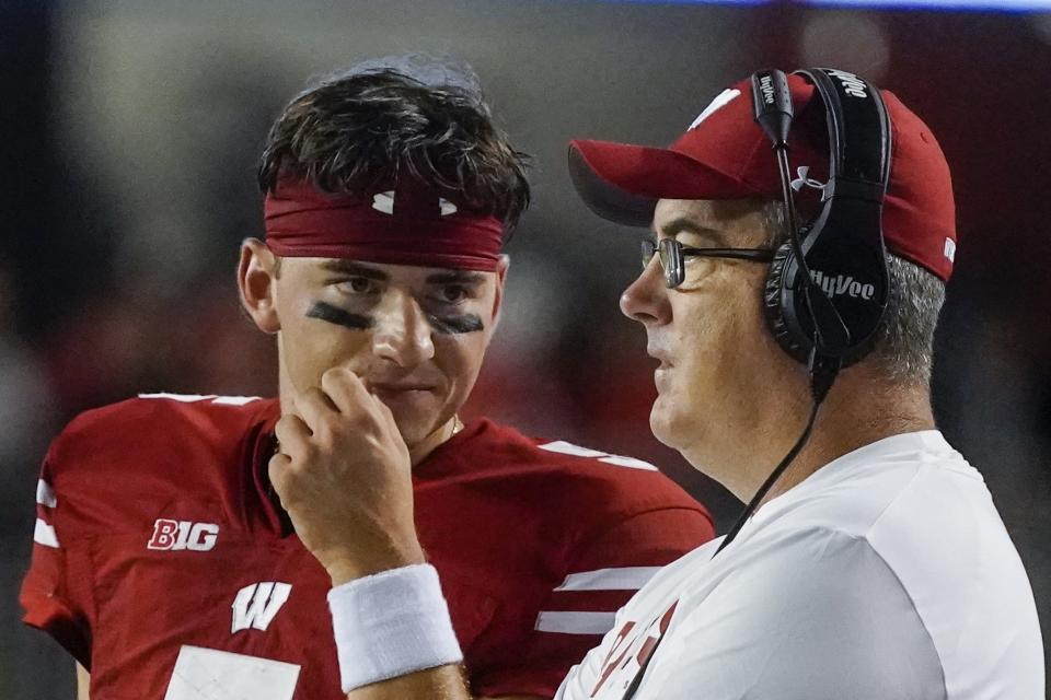 Wisconsin head coach Paul Chryst talks to Graham Mertz (5) during the second half of an NCAA college football game against Illinois State Saturday, Sept. 3, 2022, in Madison, Wis. (AP Photo/Morry Gash)