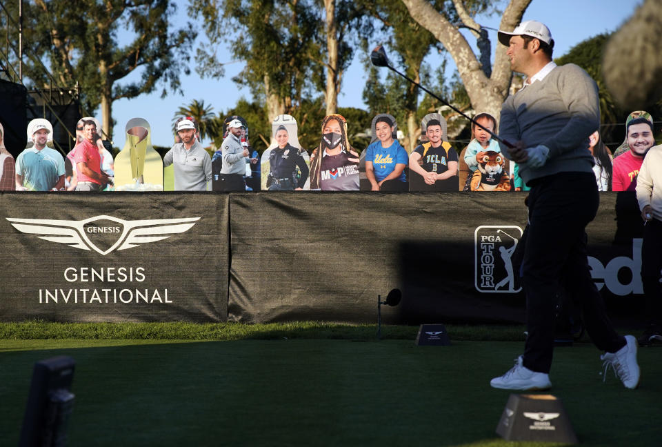 Jon Rahm tees off on the 10th hole in front of cardboard cutout fans during the first round of the Genesis Invitational golf tournament at Riviera Country Club, Thursday, Feb. 18, 2021, in the Pacific Palisades area of Los Angeles. (AP Photo/Ryan Kang)