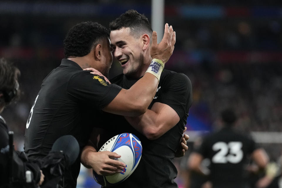 New Zealand's Will Jordan, right, celebrates after scoring a try during the Rugby World Cup semifinal match between Argentina and New Zealand at the Stade de France in Saint-Denis, outside Paris, Friday, 20, 2023. (AP Photo/Pavel Golovkin)