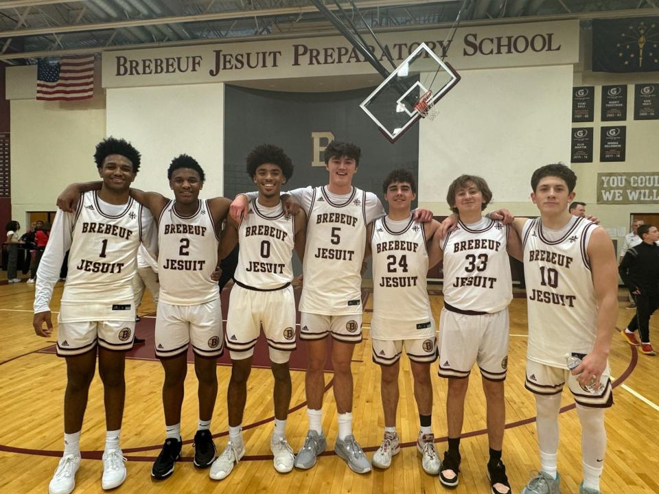 Brebeuf Jesuit student manager Aidan Brown (No. 33, second from right) with the basketball seniors on Tuesday night.