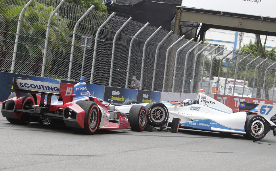 IndyCar driver Josef Newgarden, of the U.S, right collides with James Jakes, of Britain, during the IndyCar Sao Paulo 300 in Sao Paulo, Brazil, Sunday, April 29, 2012. (AP Photo/Andre Penner)