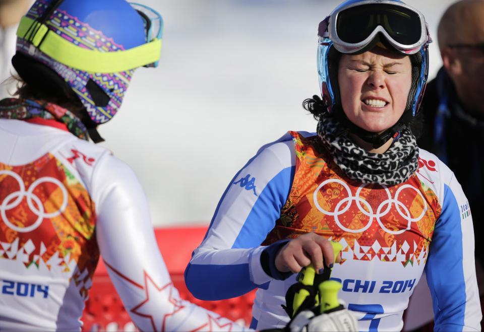 Italy's Daniela Merighetti, right, grimaces after finishing a women's downhill training run at the Sochi 2014 Winter Olympics, Thursday, Feb. 6, 2014, in Krasnaya Polyana, Russia. (AP Photo/Gero Breloer)