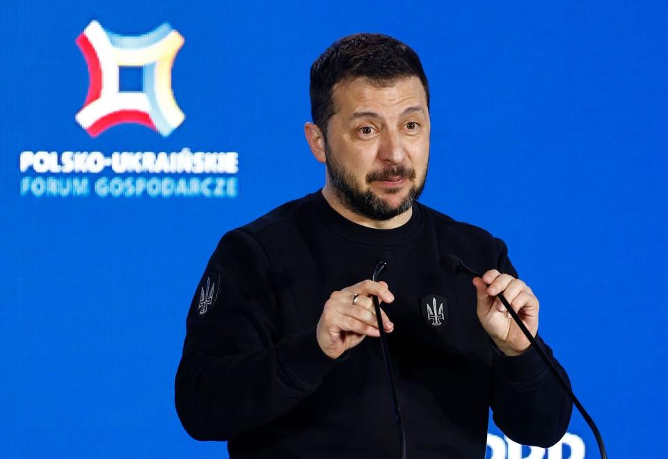 ukraine preident volodymyr zelensky speaking at a microphone